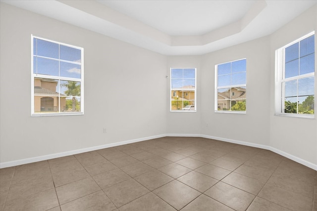 16780 Meadows St, Clermont, FL 34714 - tiled spare room with baseboards, plenty of natural light, and a tray ceiling