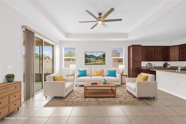 16780 Meadows St, Clermont, FL 34714 - living area with a tray ceiling, a ceiling fan, and light tile patterned floors