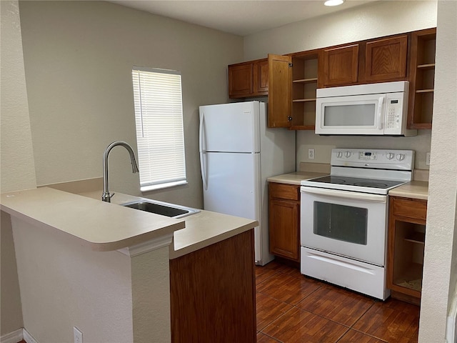 kitchen with a sink, brown cabinets, open shelves, and white appliances