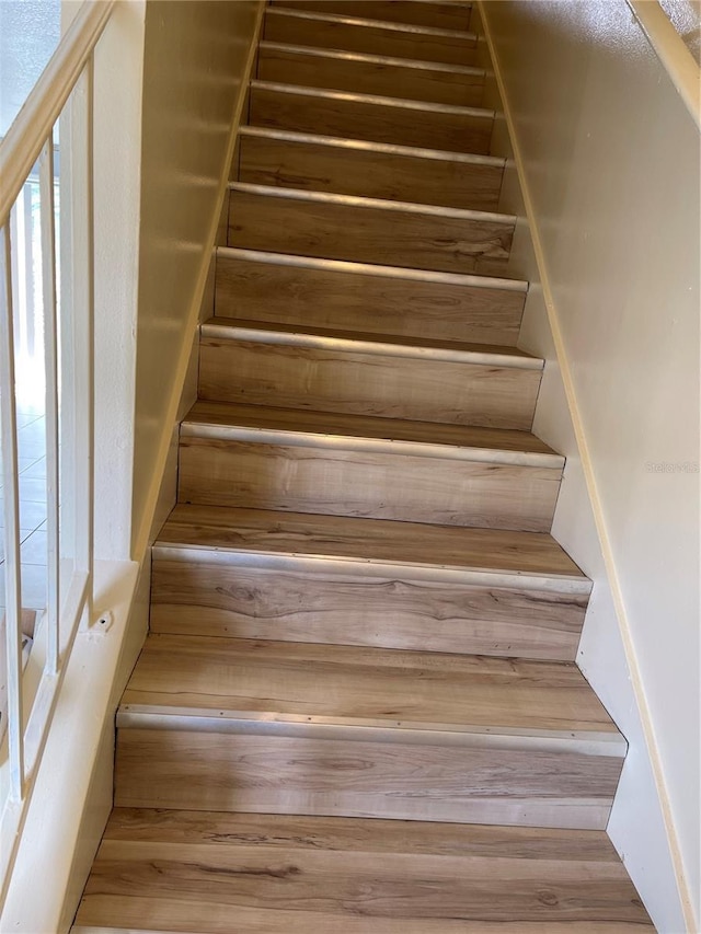 staircase featuring wood finished floors