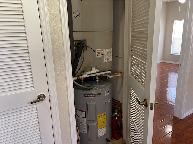 utility room featuring electric water heater
