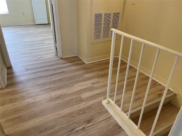 stairs featuring baseboards and wood finished floors