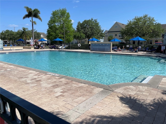 pool featuring fence and a patio