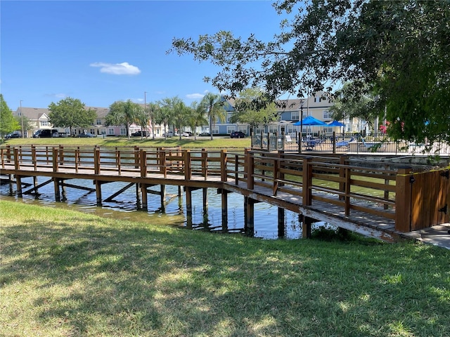 dock area featuring a lawn and a residential view