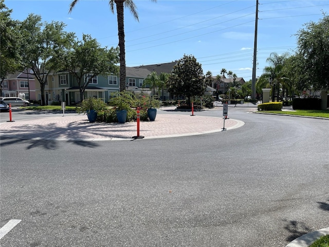 view of street with a residential view and curbs
