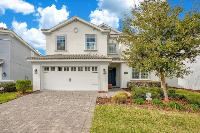 9034 Stinger Dr, Davenport, FL 33896 - traditional home featuring stucco siding, an attached garage, and decorative driveway