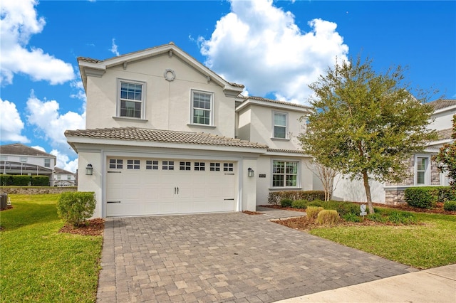 9034 Stinger Dr, Davenport, FL 33896 - view of front of property featuring a tiled roof, a front yard, a garage, decorative driveway, and stucco siding