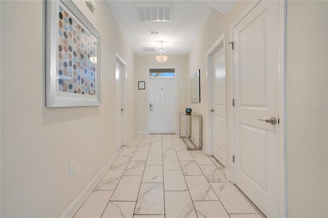 9034 Stinger Dr, Davenport, FL 33896 - entryway with baseboards, visible vents, and marble finish floor