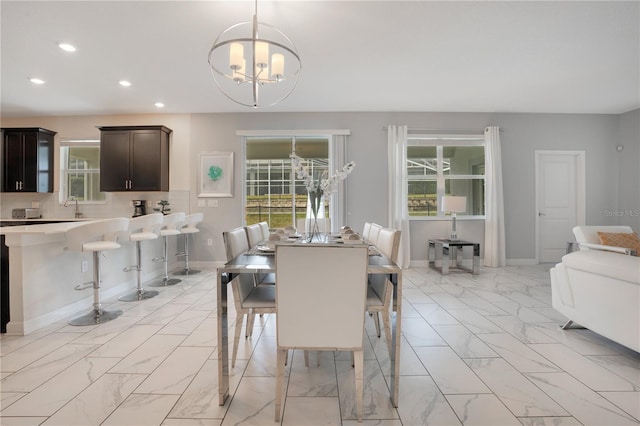 9034 Stinger Dr, Davenport, FL 33896 - dining space with baseboards, marble finish floor, recessed lighting, and a chandelier