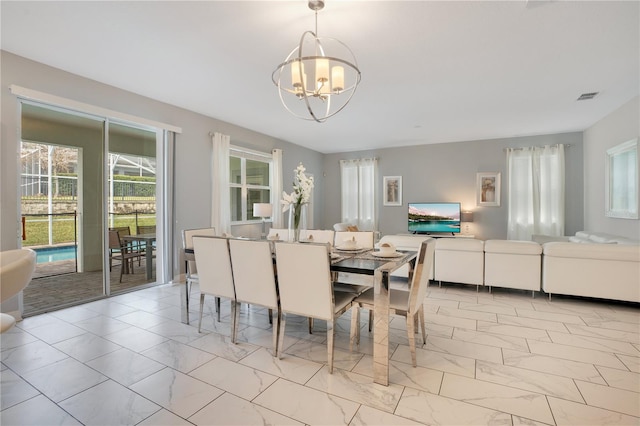 9034 Stinger Dr, Davenport, FL 33896 - dining room with visible vents, marble finish floor, and a chandelier