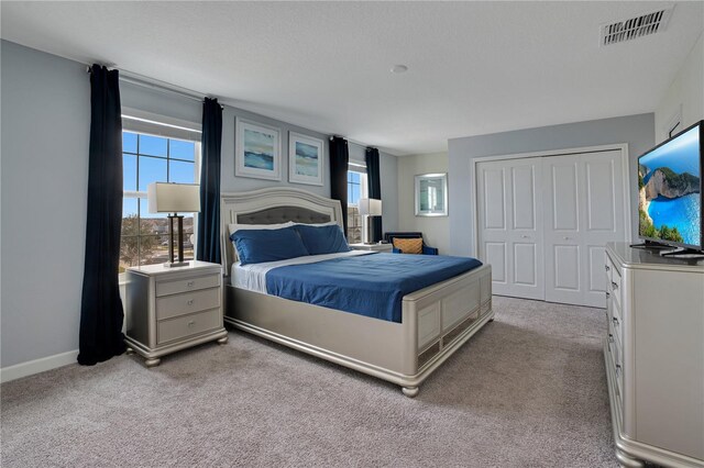 9034 Stinger Dr, Davenport, FL 33896 - bedroom with carpet flooring, visible vents, multiple windows, and a closet