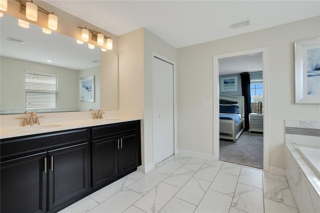 9034 Stinger Dr, Davenport, FL 33896 - ensuite bathroom featuring a sink, marble finish floor, and visible vents