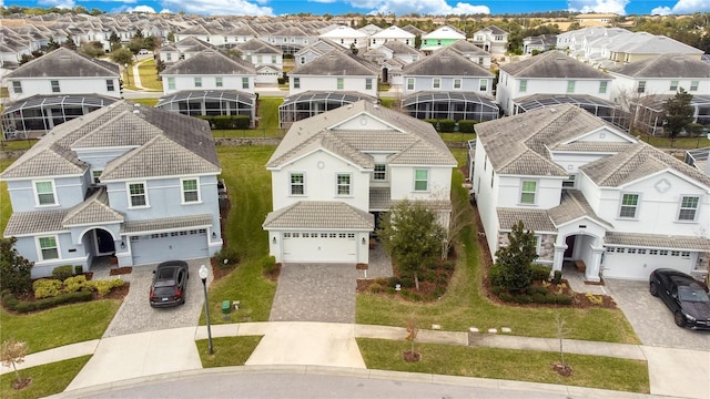 9034 Stinger Dr, Davenport, FL 33896 - view of front of property featuring a tiled roof, decorative driveway, an attached garage, and a residential view