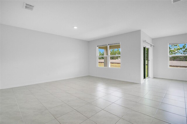 unfurnished room featuring baseboards, recessed lighting, light tile patterned flooring, and visible vents