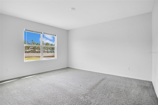 empty room with carpet flooring and baseboards