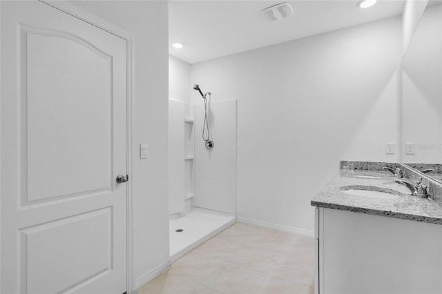 full bath with double vanity, walk in shower, a sink, and visible vents