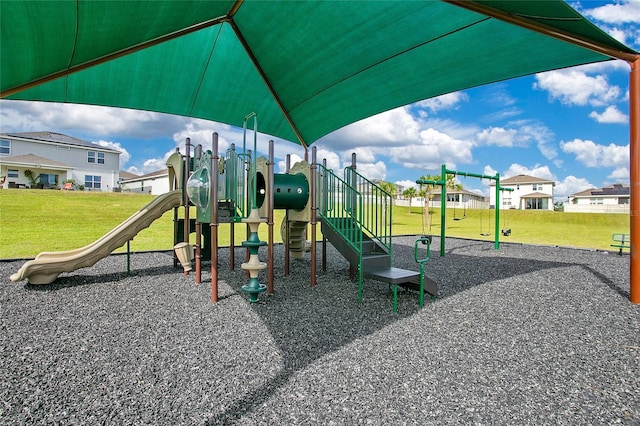community playground featuring a lawn and a residential view