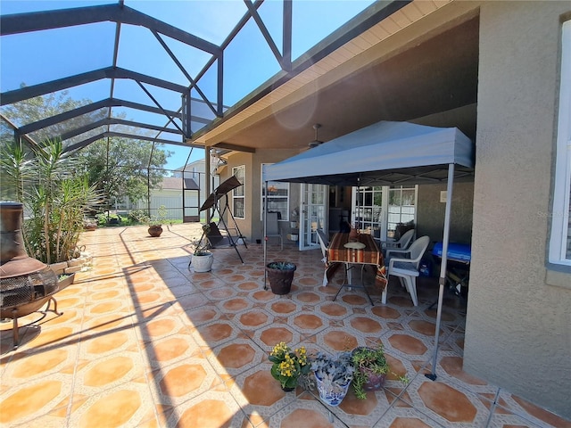 view of patio featuring glass enclosure