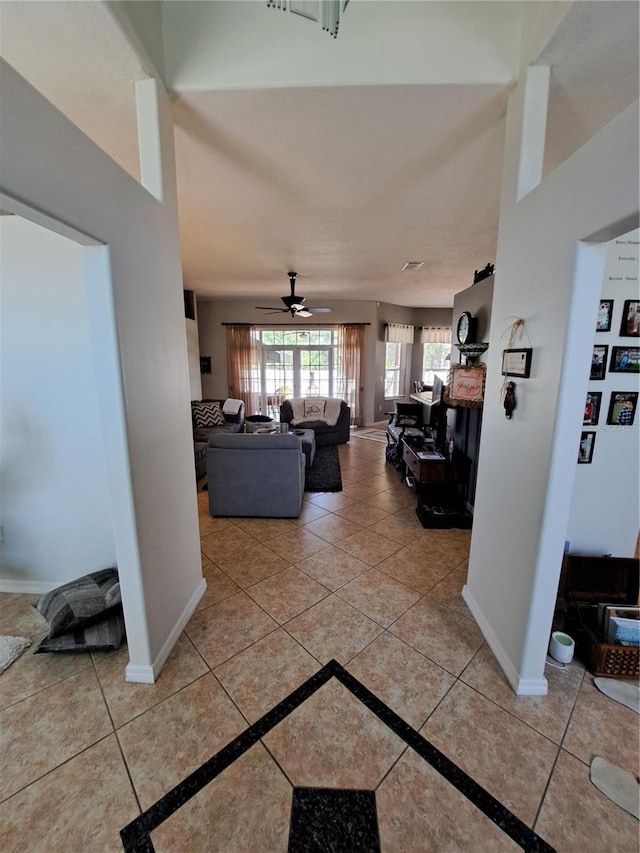 corridor featuring baseboards and tile patterned flooring