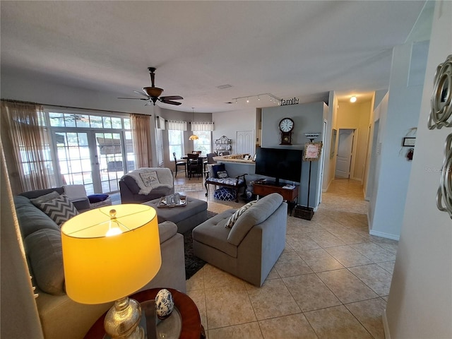 living room featuring french doors, light tile patterned flooring, a ceiling fan, and baseboards