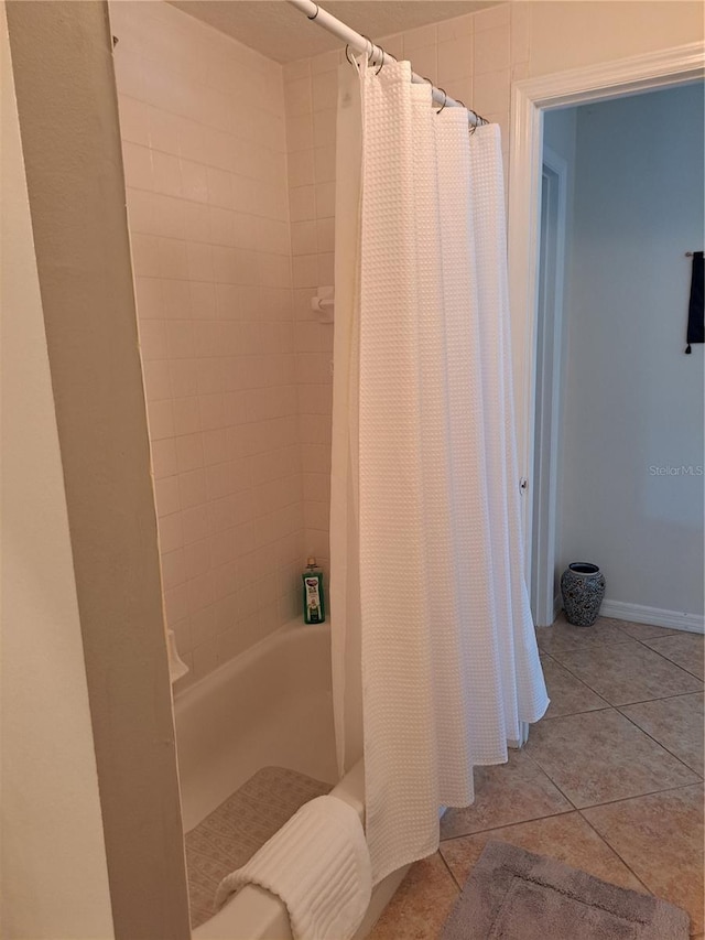bathroom with tile patterned flooring and shower / tub combo with curtain