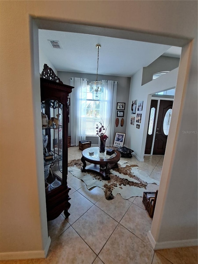 dining area with tile patterned floors, baseboards, a notable chandelier, and visible vents