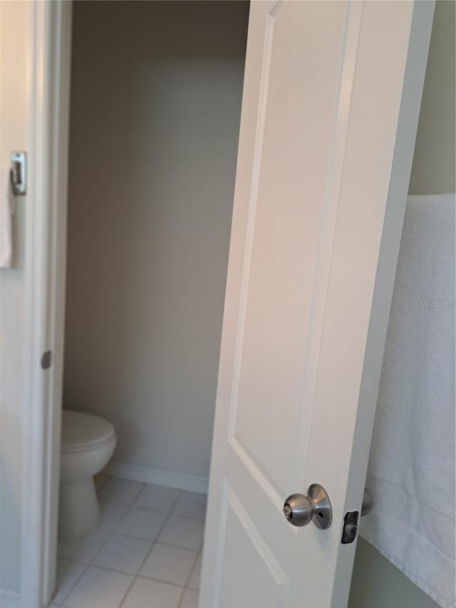 bathroom featuring toilet and tile patterned floors