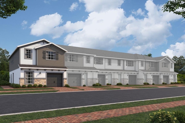 view of building exterior featuring a garage and driveway