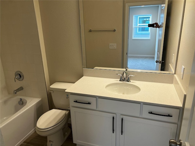 bathroom featuring toilet, vanity, and shower / bathtub combination