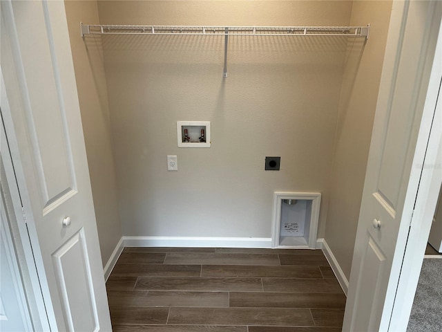 clothes washing area featuring electric dryer hookup, wood finish floors, washer hookup, and baseboards