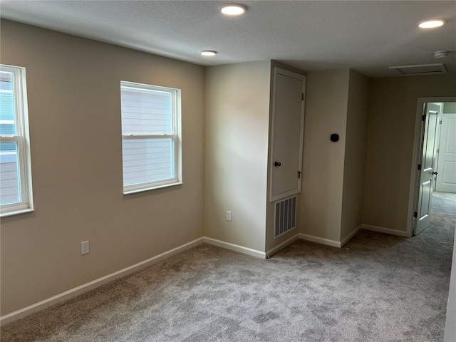 carpeted spare room with baseboards