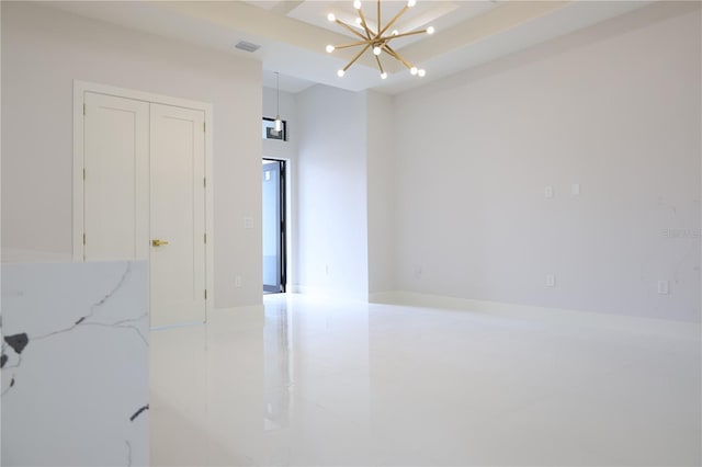 empty room featuring an inviting chandelier and visible vents