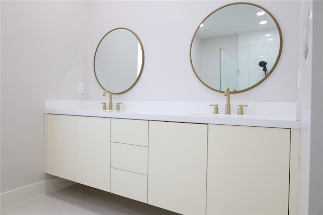 bathroom featuring recessed lighting, double vanity, and a sink