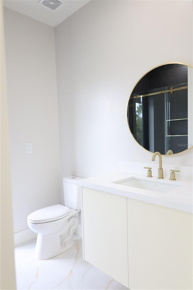 bathroom with vanity, visible vents, toilet, and marble finish floor