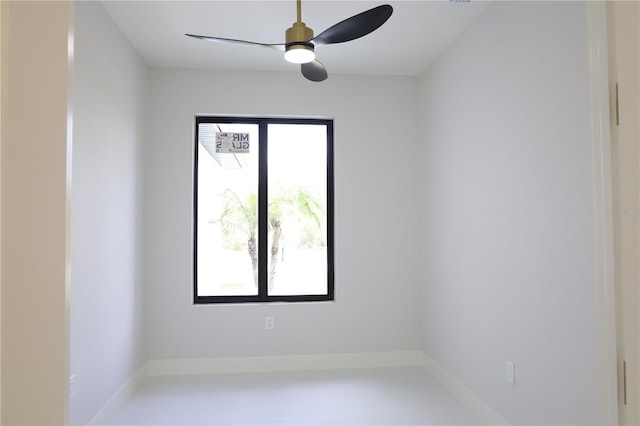 spare room with baseboards, ceiling fan, and a healthy amount of sunlight