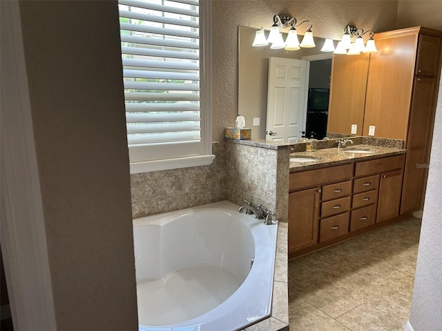 bathroom featuring double vanity, a sink, a bath, and a healthy amount of sunlight