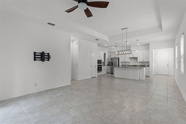 unfurnished living room featuring ceiling fan, recessed lighting, baseboards, and light tile patterned floors