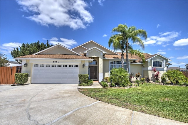 single story home featuring stucco siding, driveway, and a garage