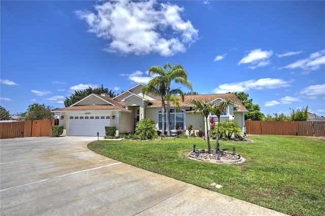 single story home featuring stucco siding, an attached garage, and concrete driveway