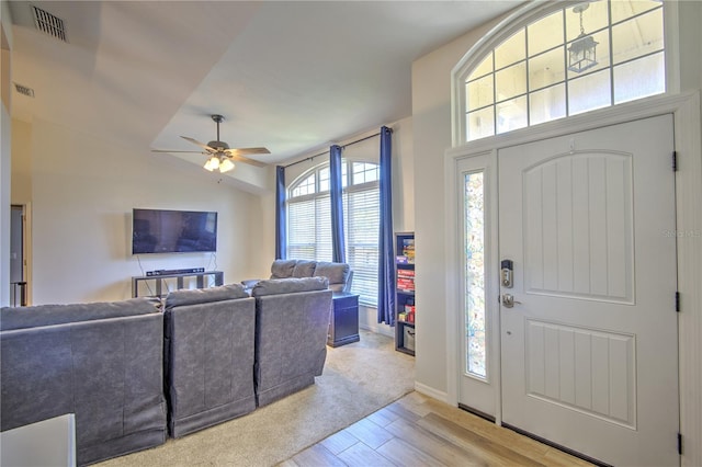 entryway featuring light wood-type flooring, a ceiling fan, and baseboards