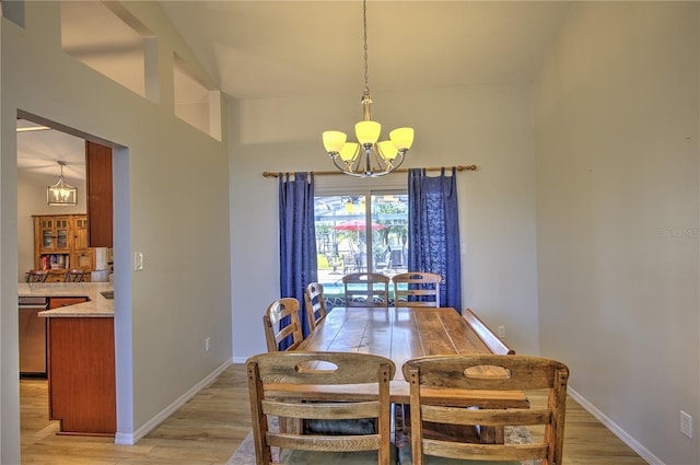 dining space featuring a chandelier, light wood-style flooring, and baseboards