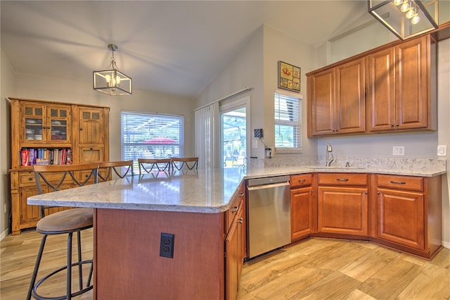 kitchen with dishwasher, a sink, light wood finished floors, a chandelier, and lofted ceiling