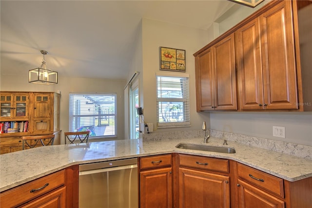 kitchen with stainless steel dishwasher, a sink, plenty of natural light, and brown cabinetry