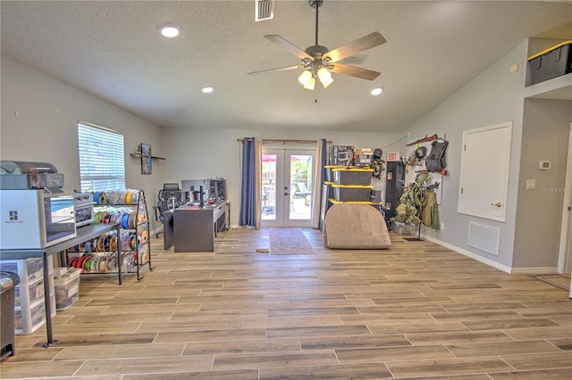 home office featuring healthy amount of natural light, french doors, recessed lighting, ceiling fan, and light wood-type flooring