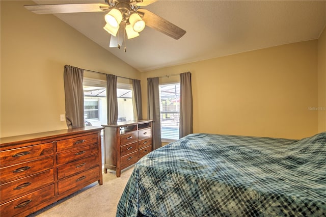 bedroom with light carpet, vaulted ceiling, and a ceiling fan