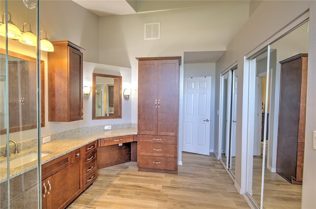 bathroom with wood finished floors and vanity