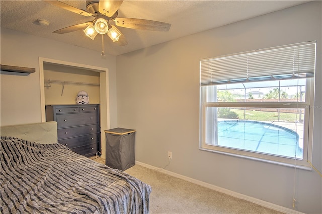 bedroom featuring light colored carpet, ceiling fan, and baseboards