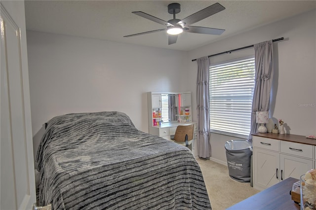 bedroom with light colored carpet, ceiling fan, and baseboards