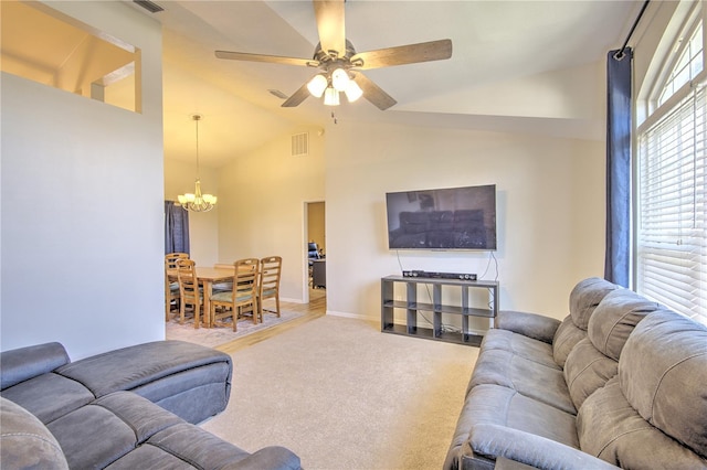 living room featuring a chandelier, ceiling fan, carpet floors, baseboards, and high vaulted ceiling