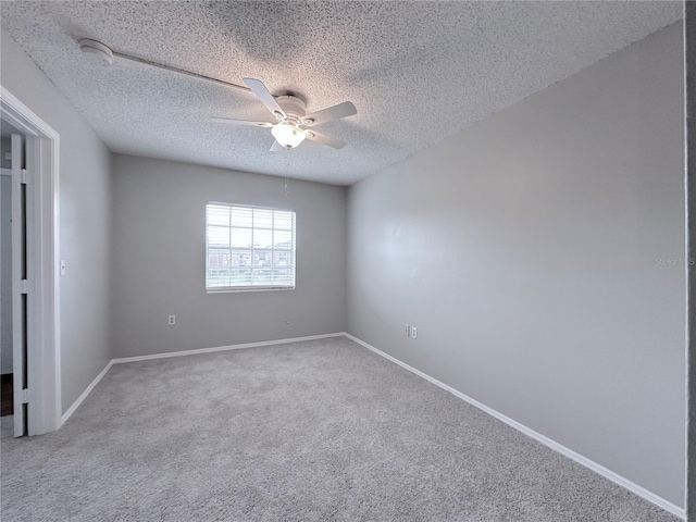 unfurnished room featuring ceiling fan, a textured ceiling, carpet, and baseboards